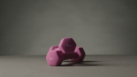 Fitness-Studio-Shot-Of-Exercise-Dumbbell-Weights-Against-Grey-Background-3