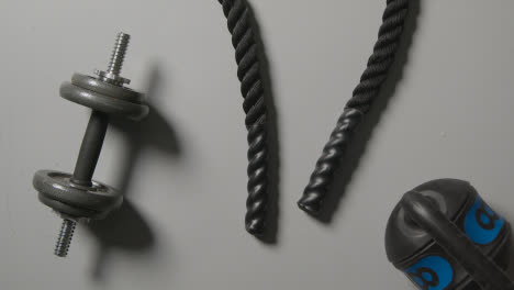 Overhead-Studio-Fitness-Shot-Of-Gym-Weights-And-Battle-Rope-On-Grey-Background