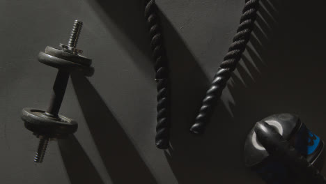 Overhead-Studio-Fitness-Shot-Of-Gym-Weights-And-Battle-Rope-On-Grey-Background-1