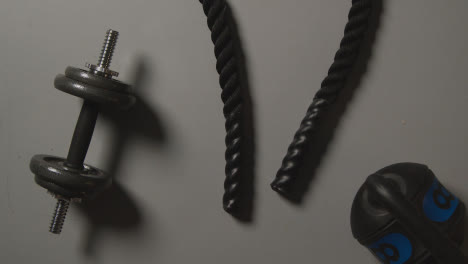 Overhead-Studio-Fitness-Shot-Of-Gym-Weights-And-Battle-Rope-On-Grey-Background-2