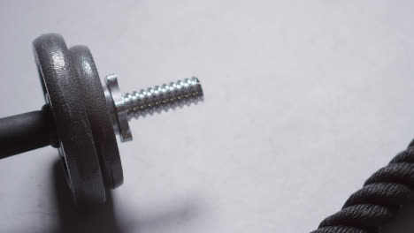 Close-Up-Studio-Fitness-Shot-Of-Gym-Weights-And-Battle-Rope-On-Grey-Background