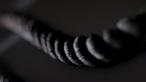 Handheld-Close-Up-Studio-Fitness-Shot-Of-Gym-Battle-Rope-Against-Backlight