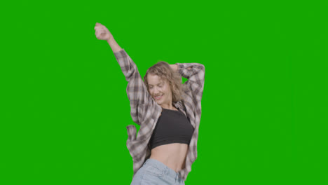 Studio-Shot-Of-Young-Woman-Having-Fun-Dancing-Against-Green-Screen-2