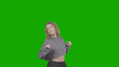 Studio-Shot-Of-Young-Woman-Having-Fun-Dancing-Against-Green-Screen-8