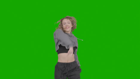Studio-Shot-Of-Young-Woman-Having-Fun-Dancing-Against-Green-Screen-15