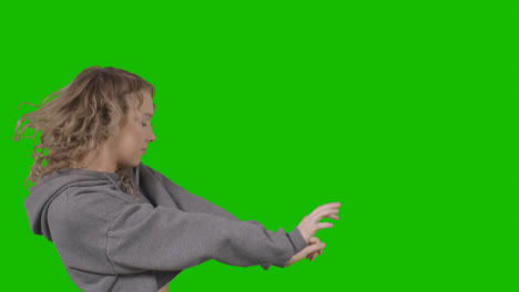 Studio-Shot-Of-Young-Woman-Having-Fun-Dancing-Against-Green-Screen-16