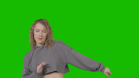 Studio-Shot-Of-Young-Woman-Having-Fun-Dancing-Against-Green-Screen-17