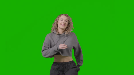 Studio-Shot-Of-Young-Woman-Having-Fun-Dancing-Against-Green-Screen-18