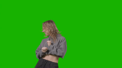 Studio-Shot-Of-Young-Woman-Having-Fun-Dancing-Against-Green-Screen-22
