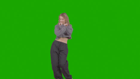Studio-Shot-Of-Young-Woman-Having-Fun-Dancing-Against-Green-Screen-25