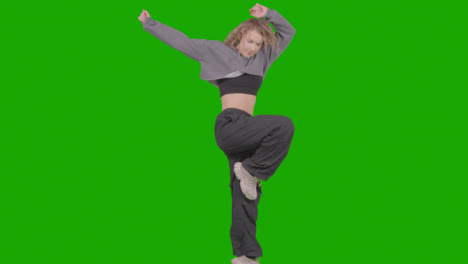 Studio-Shot-Of-Young-Woman-Having-Fun-Dancing-Against-Green-Screen-29