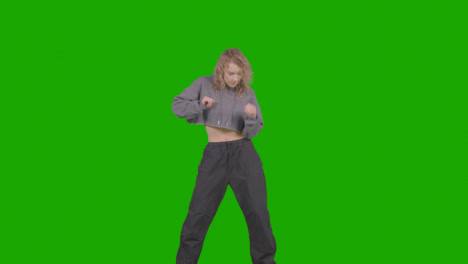 Studio-Shot-Of-Young-Woman-Having-Fun-Dancing-Against-Green-Screen-30