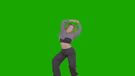 Studio-Shot-Of-Young-Woman-Having-Fun-Dancing-Against-Green-Screen-32