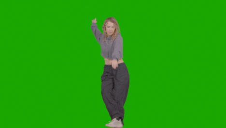 Studio-Shot-Of-Young-Woman-Having-Fun-Dancing-Against-Green-Screen-37