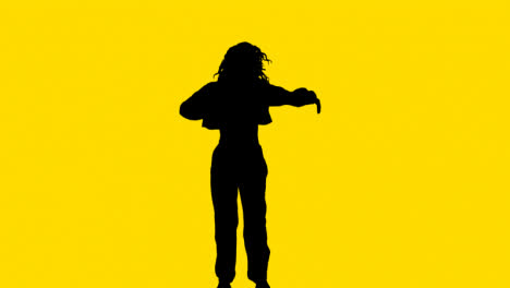 Studio-Silhouette-Of-Woman-Dancing-Against-Yellow-Background