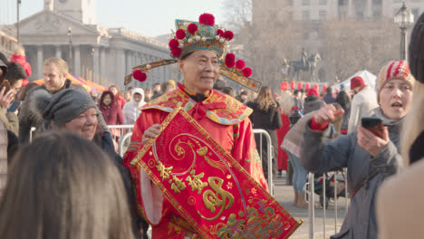 Man-Wearing-Traditional-Costume-Celebrating-Chinese-New-Year-2023-In-Trafalgar-Square-London-UK