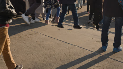 Close-Up-Of-Feet-Walking-Up-Steps-In-Busy-City