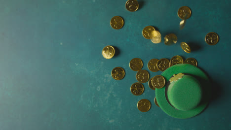 Overhead-Studio-Shot-Of-Green-Leprechaun-Top-Hat-And-Piles-Of-Gold-Coins-To-Celebrate-St-Patricks-Day-3