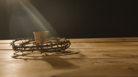 Religious-Concept-Shot-Of-Chalice-With-Crown-Of-Thorns-Placed-Around-It-On-Wooden-Background-