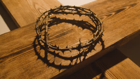Religious-Concept-Shot-With-Crown-Of-Thorns-And-Wooden-Cross-In-Pool-Of-Light-2