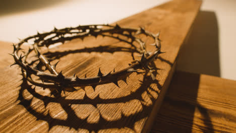 Religious-Concept-Shot-With-Crown-Of-Thorns-And-Wooden-Cross-In-Pool-Of-Light-2