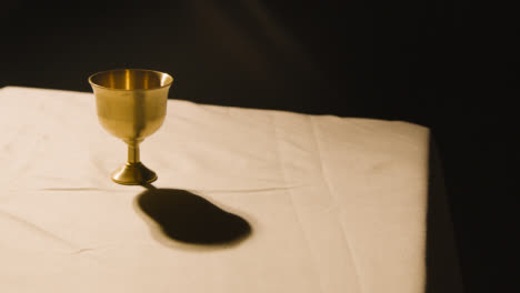 Religious-Concept-Shot-With-Chalice-On-Altar-In-Pool-Of-Light-2