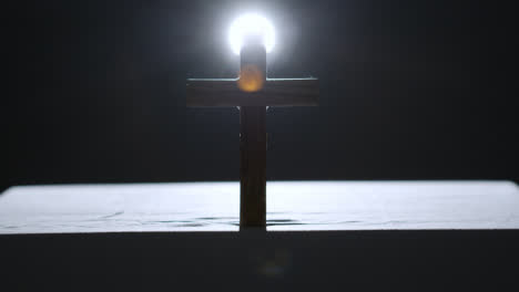 Religious-Concept-Shot-With-Wooden-Cross-On-Altar-With-Spotlight-Behind-2