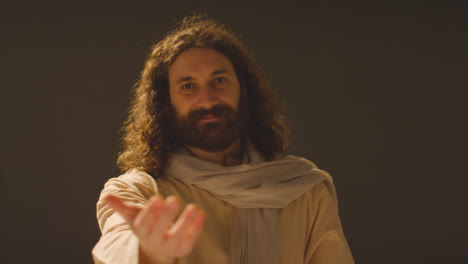 Portrait-Of-Man-With-Long-Hair-And-Beard-Representing-Figure-Of-Jesus-Christ-Extending-Hand-In-Friendship