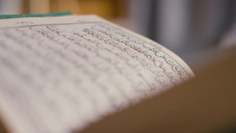 Close-Up-Of-Open-Copy-Of-The-Quran-On-Stand-At-Home-7