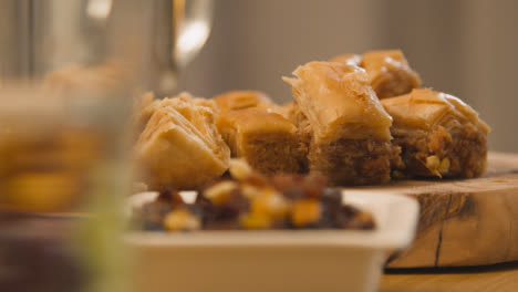 Close-Up-Of-Baklava-On-Muslim-Family-Table-In-Home-Set-For-Meal-Celebrating-Eid