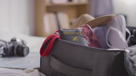 Close-Up-Of-Open-Suitcase-On-Bed-At-Home-Being-Packed-For-Summer-Holiday-7