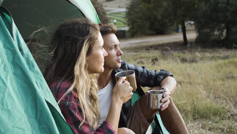 Couple-of-happy-pensive-hikers-drinking-coffee