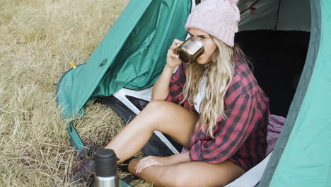 Pensive-camping-girl-wearing-warm-woolen-hat