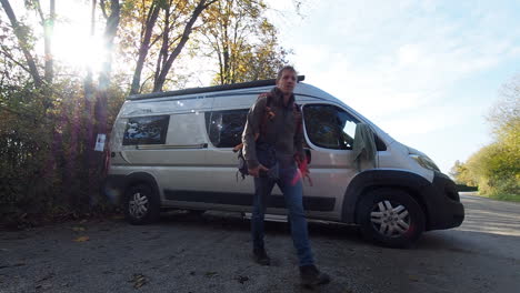 Traveling-vlogger-leaving-conversion-van-for-hike-in-woods-of-Eifel-Germany