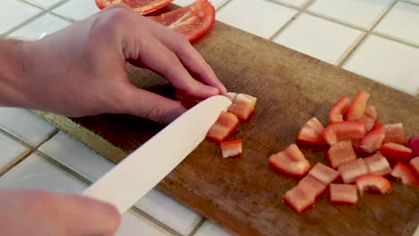 Cutting-Paprika-on-wooden-board-in-kitchen,-400%-Speed