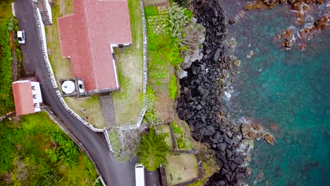 Topdown-shot-of-Santa-Barbara-church-and-Manadas-coast-in-Sao-Jorge-Island,-Azores