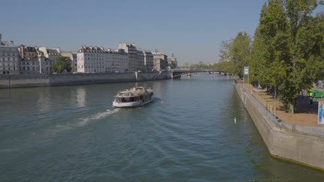 Tourist-Boat-Going-Under-Bridge-In-Quais-De-Seine-Area-Of-Paris-France-1