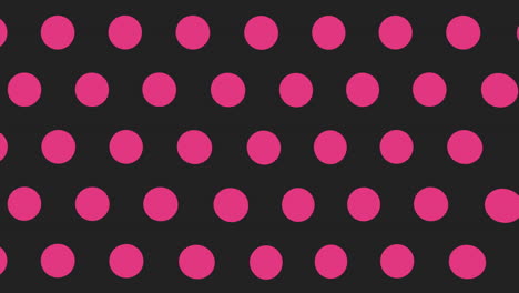 Pink-and-black-polka-dot-pattern-on-a-black-background