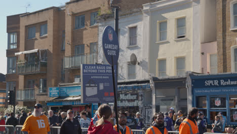 Crowd-Of-Supporters-And-Gameday-Guide-Seller-Outside-Tottenham-Hotspur-Stadium-For-2023-NFL-Games-In-London