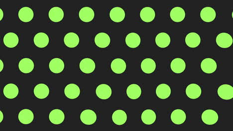 Dynamic-black-and-green-polka-dot-pattern-on-black-background