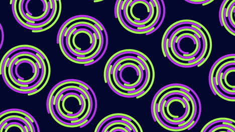 Spiraling-green-and-purple-circle-pattern-on-black-background