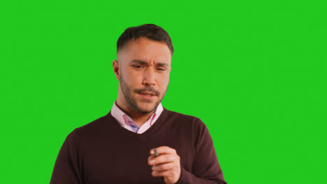 Close-Up-Studio-Portrait-Of-Mature-Male-Teacher-Talking-To-Class-Standing-Against-Green-Screen-Background-1