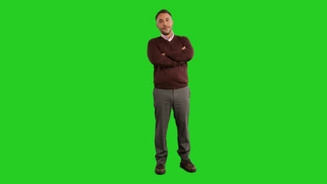 Full-Length-Studio-Portrait-Of-Mature-Male-Teacher-Or-Businessman-Standing-Against-Green-Screen