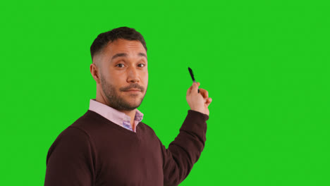 Close-Up-Studio-Portrait-Of-Mature-Male-Teacher-Talking-To-Class-Standing-Against-Green-Screen-Background-3