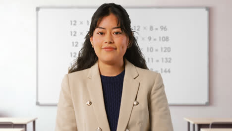 Close-Up-Shot-Of-Female-Teacher-In-Classroom-Standing-In-Front-Of-Board-Teaching-Elementary-Maths-Lesson