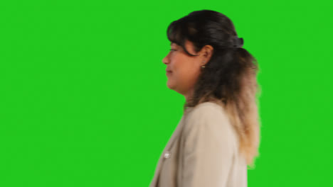 Close-Up-Studio-Profile-Shot-Of-Female-Teacher-Or-Businesswoman-Walking-Past-Green-Screen-1