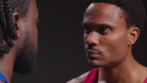 Close-Up-Of-Male-Boxer-And-Opponent-Standing-Face-To-Face-Before-Boxing-Match-Staring-At-Each-Other-4