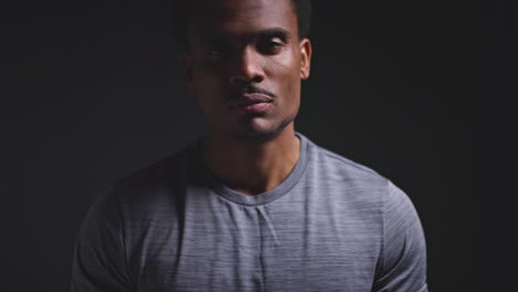 Portrait-Of-Boxer-Warming-Up-In-Training-Putting-Up-Fists-Ready-To-Fight-Against-Black-Background