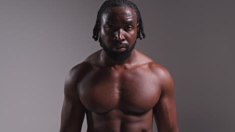 Real-Time-Studio-Portrait-Of-Bare-Chested-Male-Boxer-Recovering-And-Catching-Breath-After-Boxing-Match