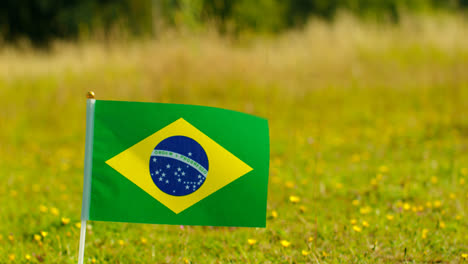 Close-Up-Of-Small-Brazilian-National-Flag-Outdoors-In-Countryside-Field-Or-Garden-Moving-In-Wind-2